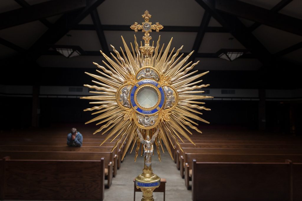 Monstrance with man in adoration